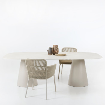 Sandro dining table in Dune White with a ceramic Portland top, paired with Akari dining chairs featuring rope detailing and white metal frames, set against a plain white background.