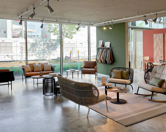 Vincent Sheppard showroom at Design Post Cologne featuring various Paper Loom and rope-woven lounge chairs, sofas, coffee tables, and fabric samples in a bright, modern space.