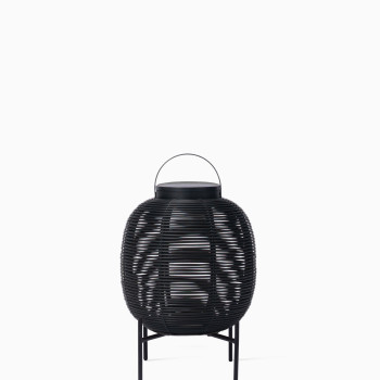 Vincent Sheppard Tika lantern with compact black woven frame, steel base, and top handle, front view.	