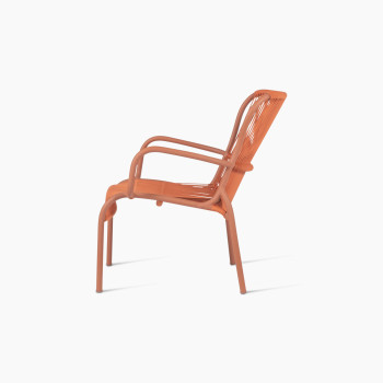 Side view of Vincent Sheppard Loop lounge chair with aluminium frame and rope in terracotta	