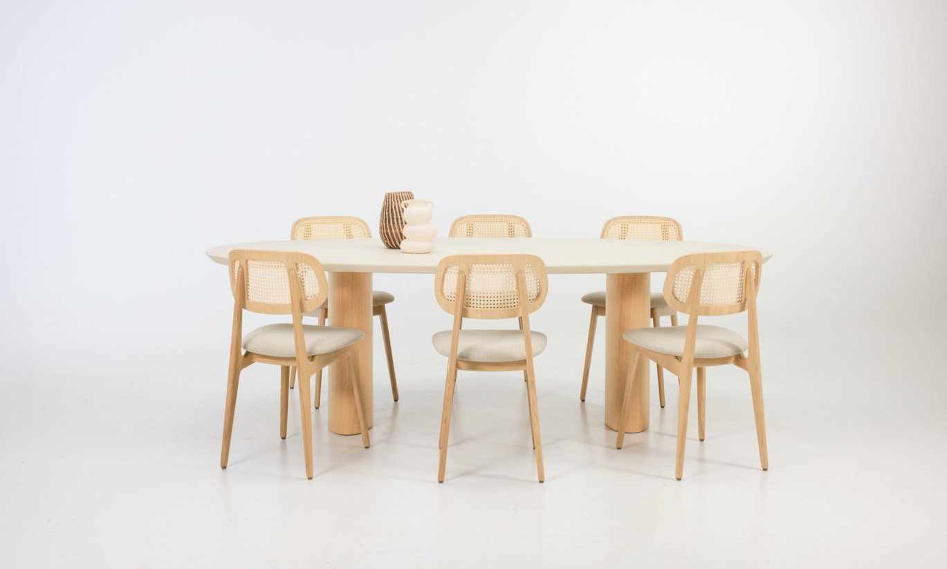 Vincent Sheppard Foster dining table with elliptical Mineral plaster top and Natural oak, surrounded by Titus dining chairs in lime white bouclé and Natural oak