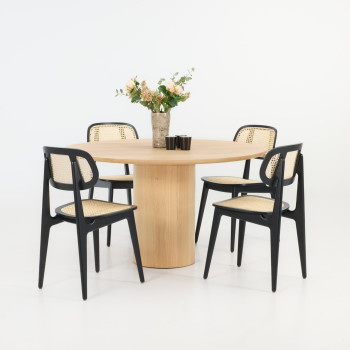 Vincent Sheppard Atlas round dining table in natural oak with Titus Lloyd Loom dining chairs in Black.	