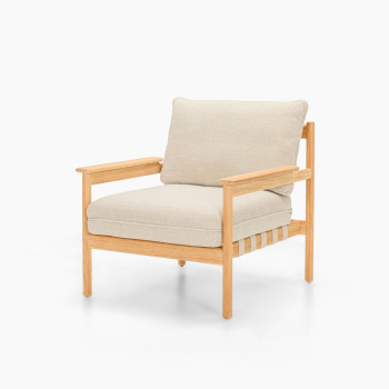 Angled view of Vincent Sheppard Oda lounge chair with Lime White bouclé cushions and raw teak frame	