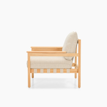 Side view of Vincent Sheppard Oda lounge chair with Lime White bouclé cushions and raw teak frame	