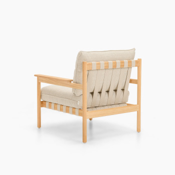 Rear three-quarter view of Vincent Sheppard Oda lounge chair with Lime White bouclé cushions and raw teak frame	