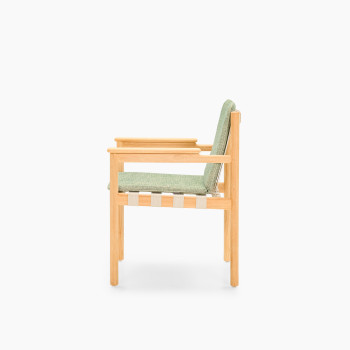 Side view of Vincent Sheppard Oda dining chair with Fig Green cushion and untreated teak frame	
