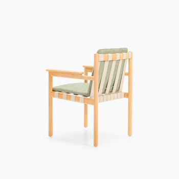 Rear three-quarter view of Vincent Sheppard Oda dining chair with Fig Green cushion and untreated teak frame	