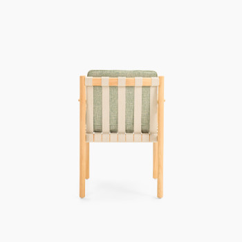 Back view of Vincent Sheppard Oda dining chair with Fig Green cushion and untreated teak frame	